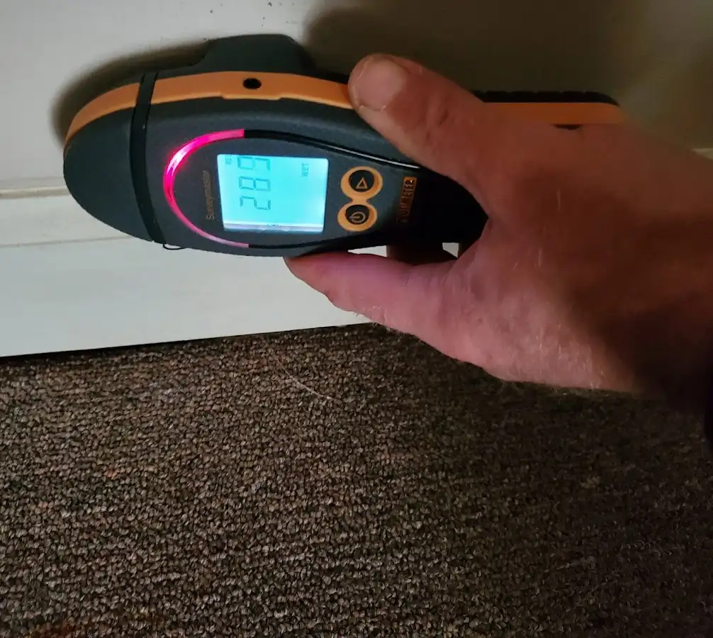 Moisture detection at baseboard during Storm Damage Restoration in Norman